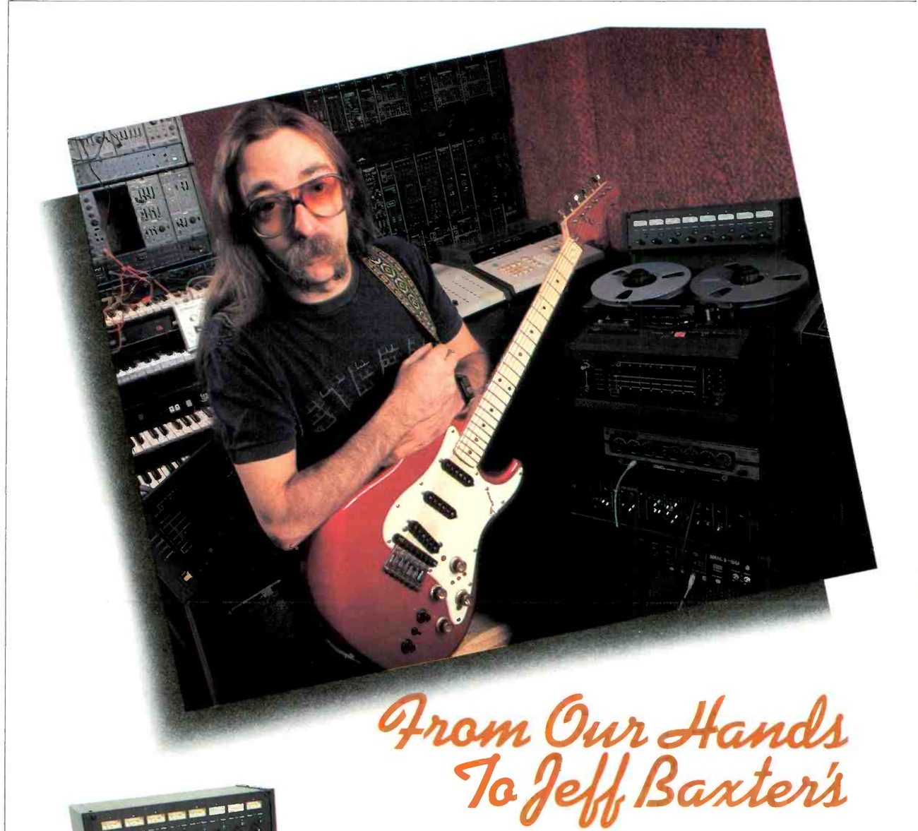 Jeff Baxter in his studio, holding a red solid-body guitar, with synthesizer modules and keyboards behind him at left and at right a tape machine with an eight-meter bridge and two reels on its transport; the script headline From Our Hands To Jeff Baxter's is set below the photograph.