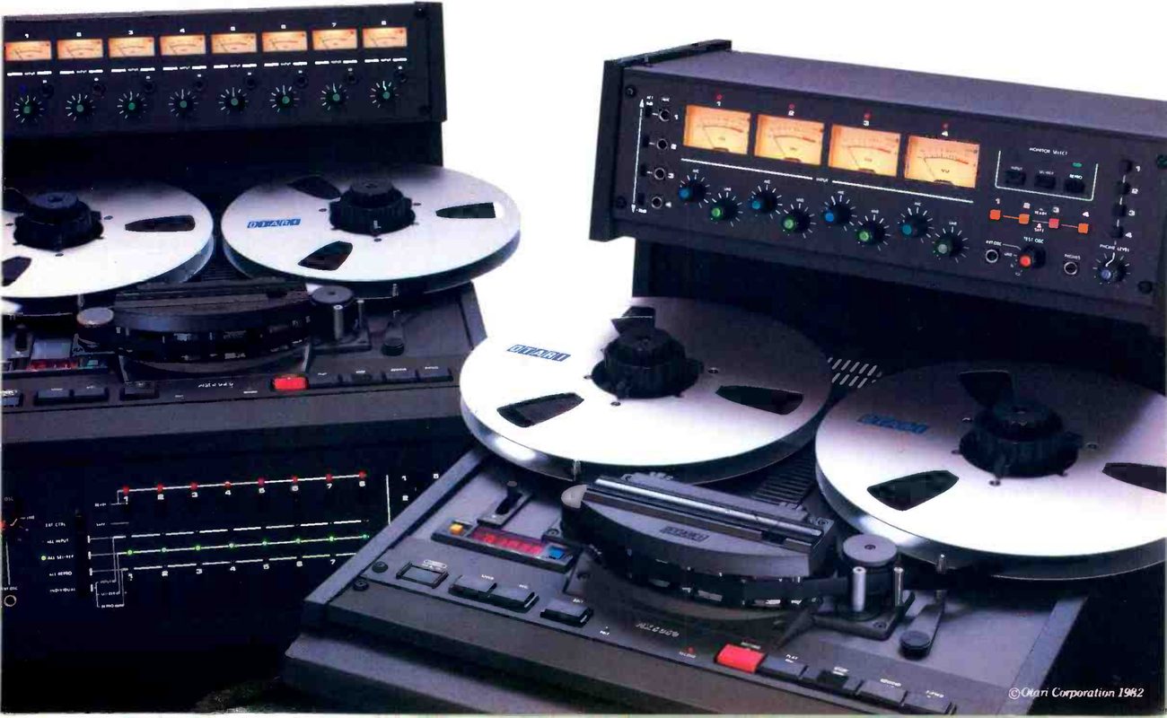 The MARK III/8 and MARK III/4 photographed side by side: at the left the eight-channel machine with its row of eight meters and level knobs above the transport and a panel of LED indicators below, and at the right the four-channel machine with four meters and knobs on a sloping overbridge, its transport in front showing two reels with OTARI on the flanges, the head assembly and the transport keys.