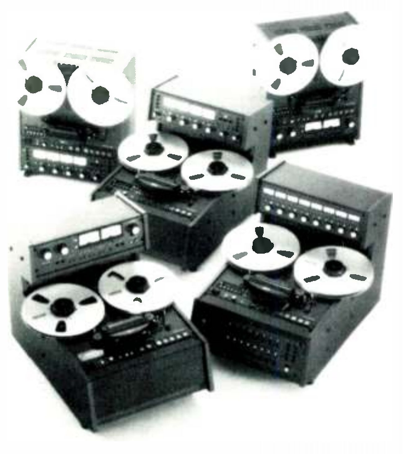 A group of fourth-generation MX-5050 machines photographed together: two upright quarter-inch machines at the back with their reels above the transport and the electronics below, and three table-top consoles in front with the reels on a sloping transport and a raised meter housing behind.
