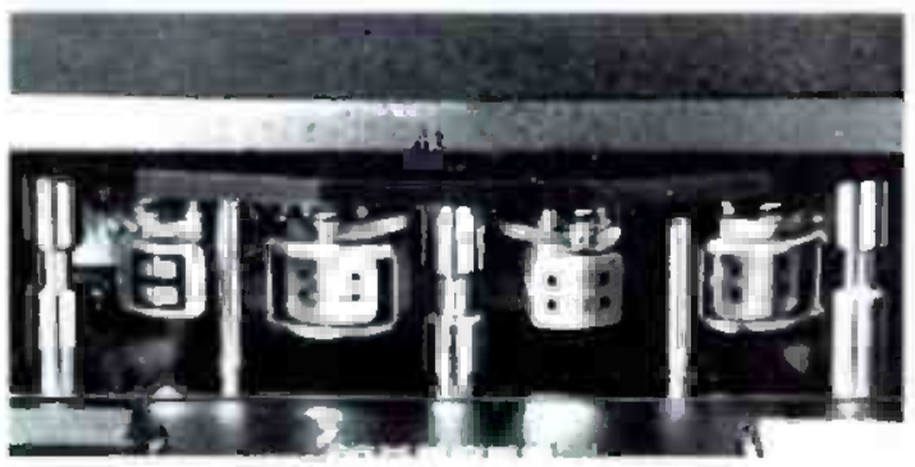 A close-up of the head block: four heads in a row between the tape guides.