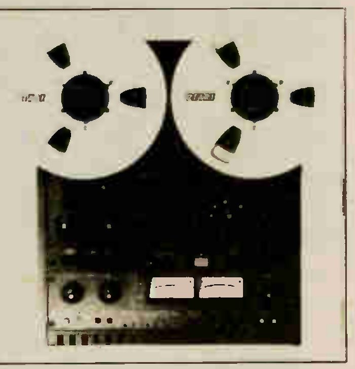 A small front-on photograph of the MX-5050 BIII: two reels on the transport, the dark deck panel below with a pair of meters and two knobs at the lower left.