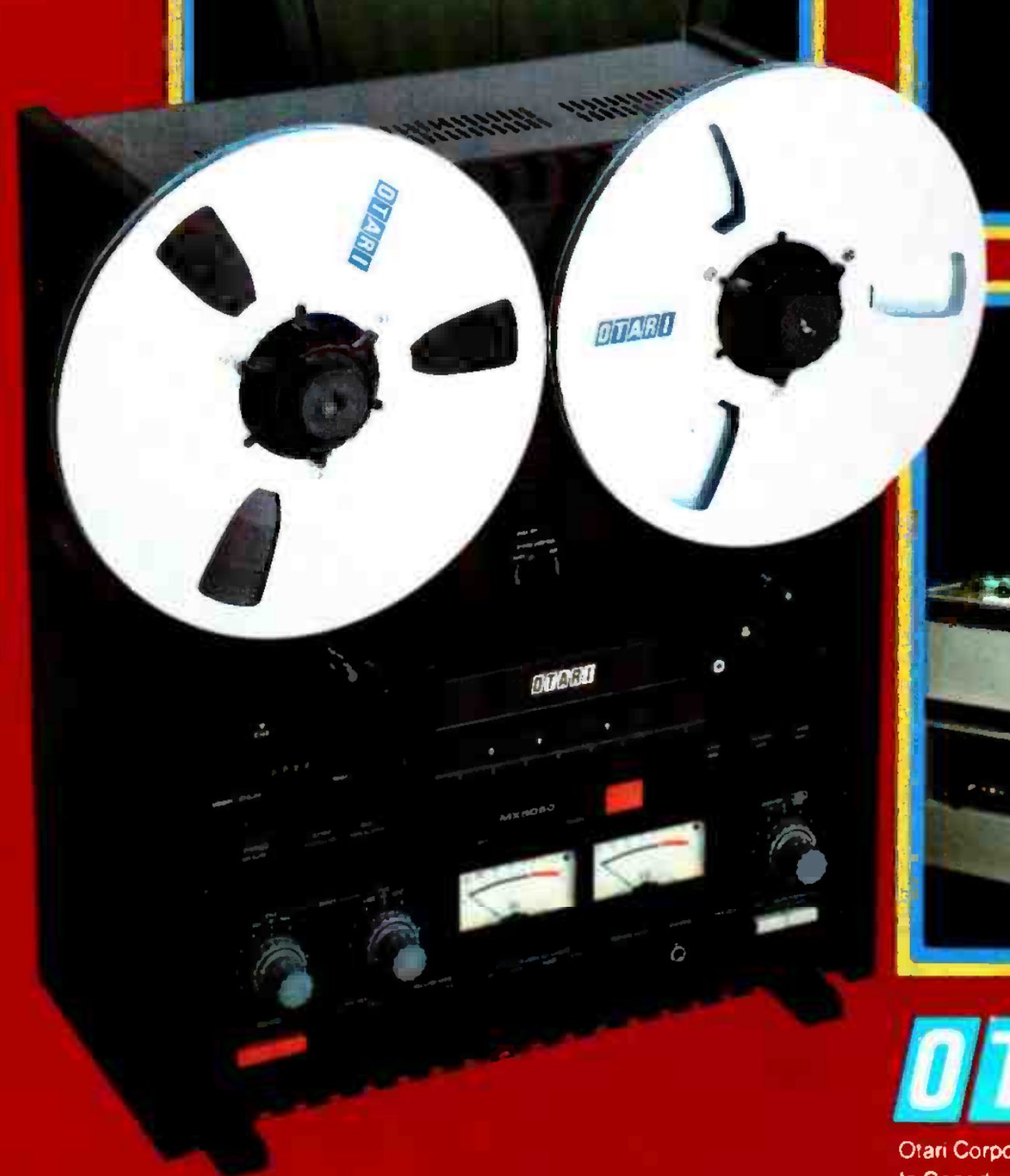 The MX-5050-B from a three-quarter angle in its black case: two OTARI reels, the OTARI badge above the transport controls, the MX5050 legend on the electronics panel between the controls, and a pair of VU meters with level knobs either side.