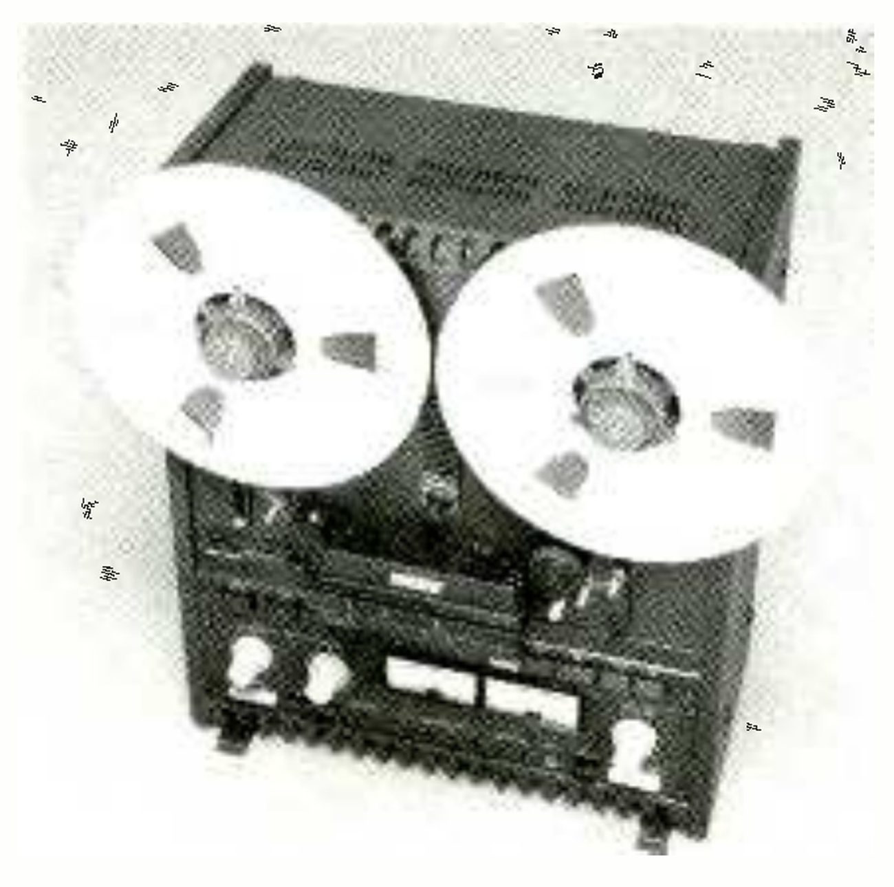 The MX-5050B from a high three-quarter angle, with a reel on each hub, the head cover and transport buttons below the reels, and the meters and level knobs on the electronics panel.
