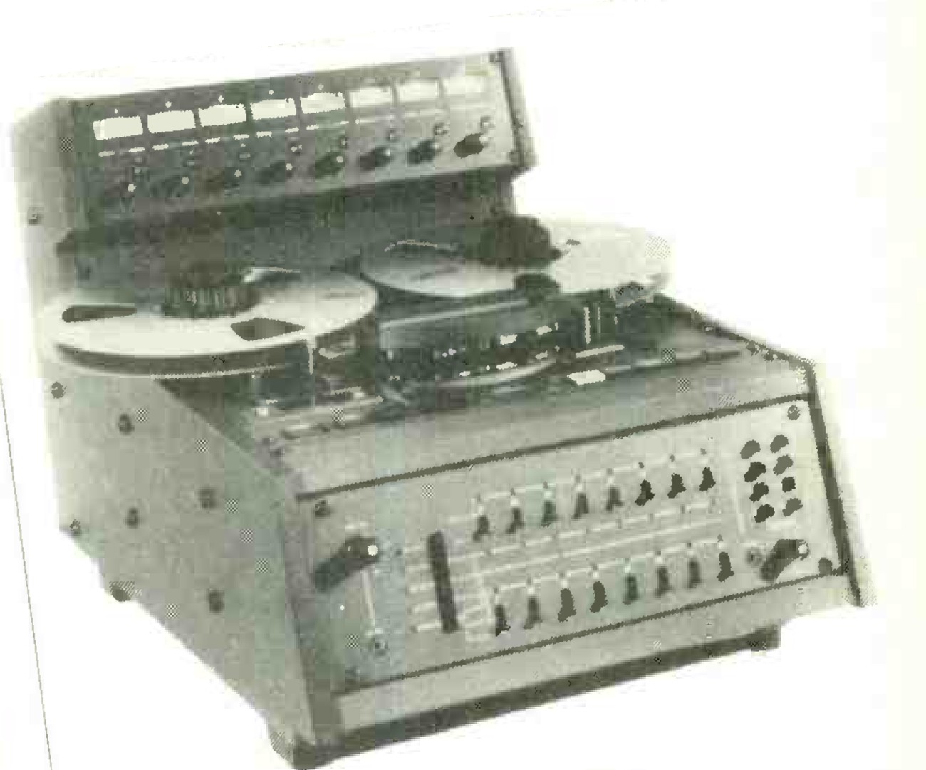 The MX5050 MkIII-8 in a sloping console housing: the transport with its reels at the top, a meter bridge of eight meters behind it, and on the front panel two rows of eight channel switches.