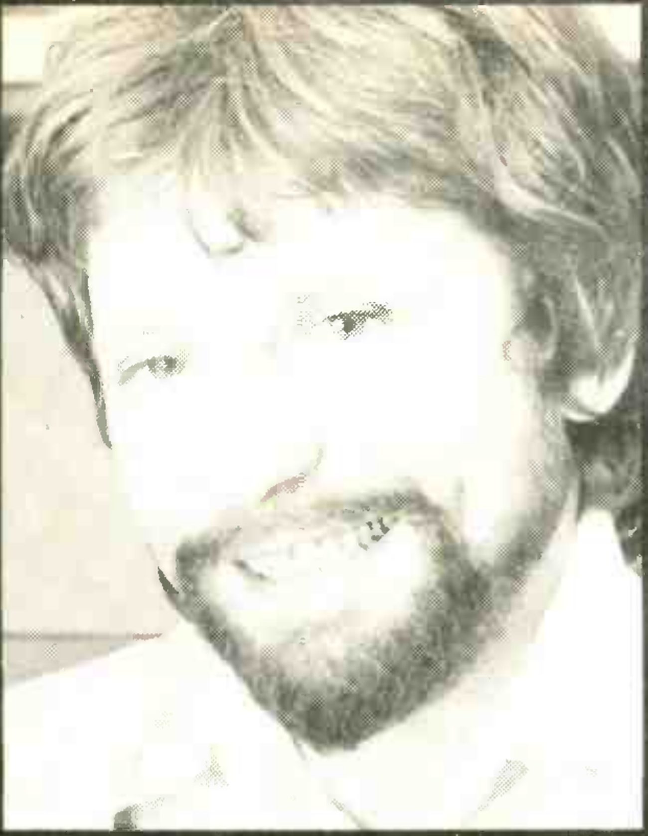 Portrait of a bearded man, set at the top left of the advertisement beside the quotation.