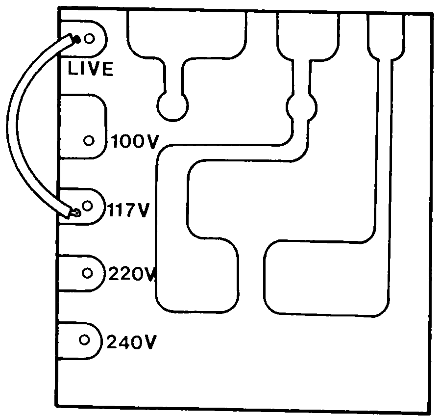 Line-art drawing of a small PCB terminal strip with labelled voltage-selection pins and a curved arrow showing the jumper wire's factory position.