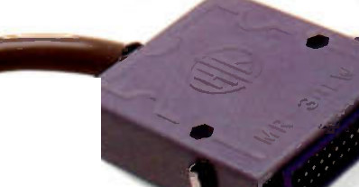 A brown multipin connector shell photographed close up against white, its cable entering from the left, two hex screw bosses on the moulded body and the pin field visible at the open end.