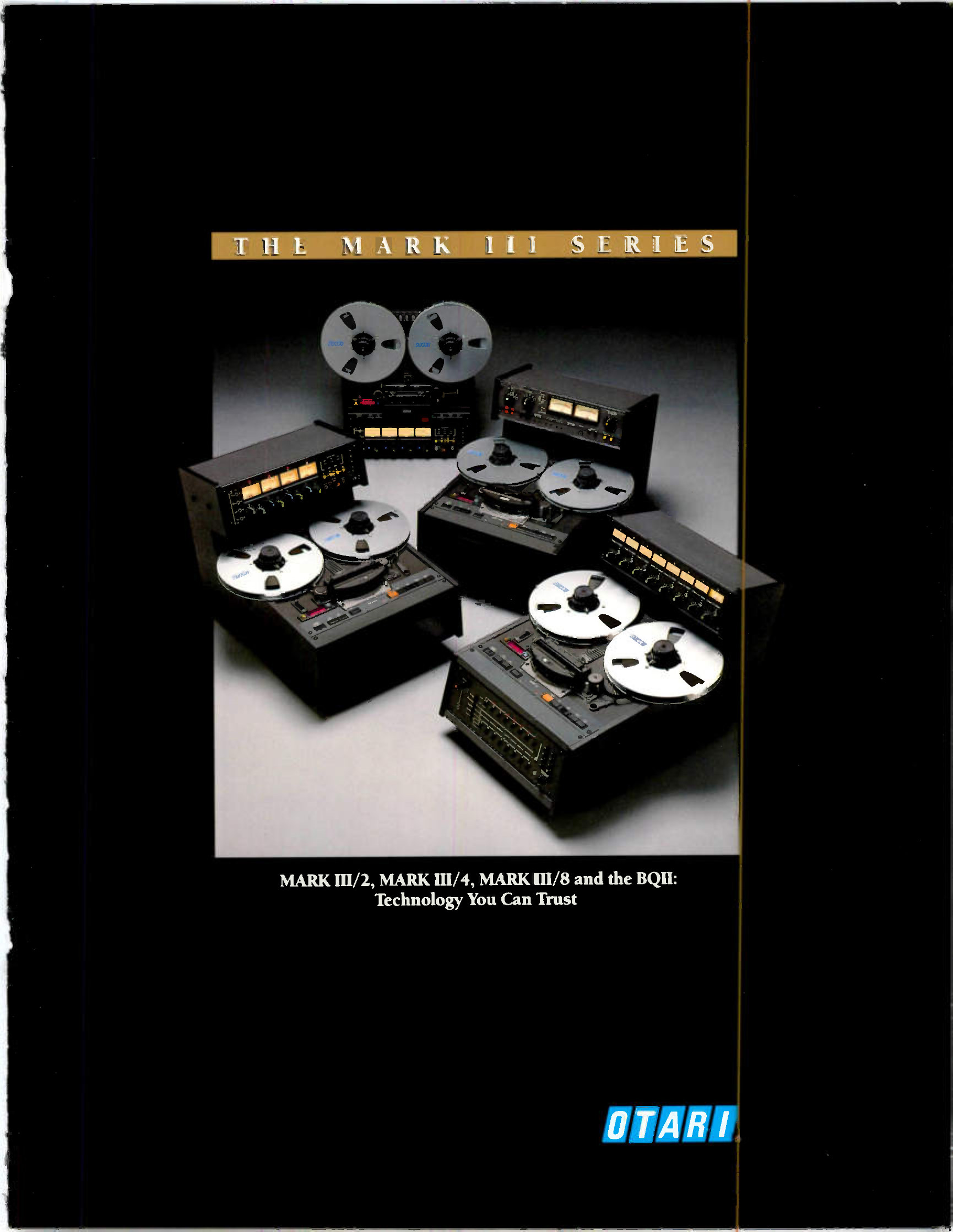 Four machines grouped on a grey seamless background, each with white NAB reels fitted: two desk-top recorders with separate meter units behind them, and two more in front, one with an eight-channel meter bridge standing to its right.