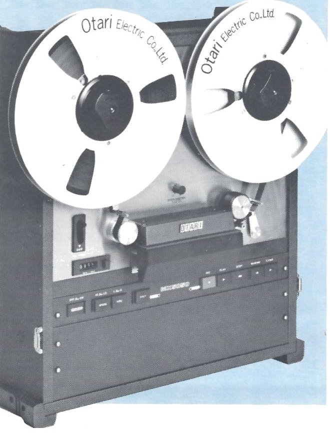 The MX-5050-8 transport in its vinyl-covered case, standing upright with two 10½ inch reels marked Otari Electric Co.,Ltd., the head cover across the middle and the transport push-buttons below it