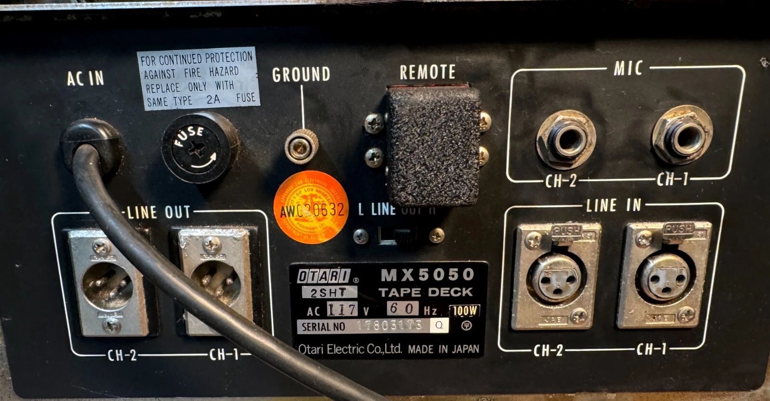 The factory dummy plug on another first-generation deck — crinkle black in the REMOTE socket, easy to overlook.