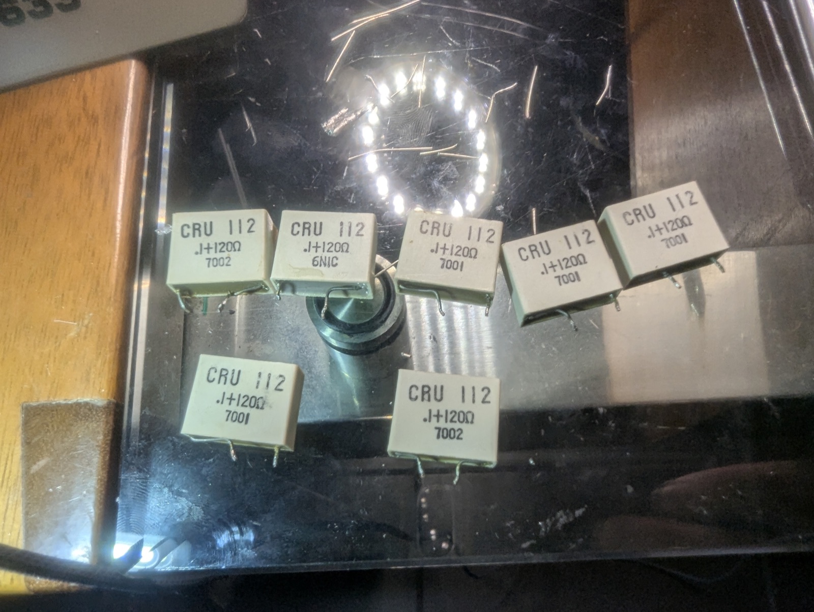 The switch board's spark quenchers, freshly pulled — 0.1 µF and 120 Ω, one across every switch on the board.