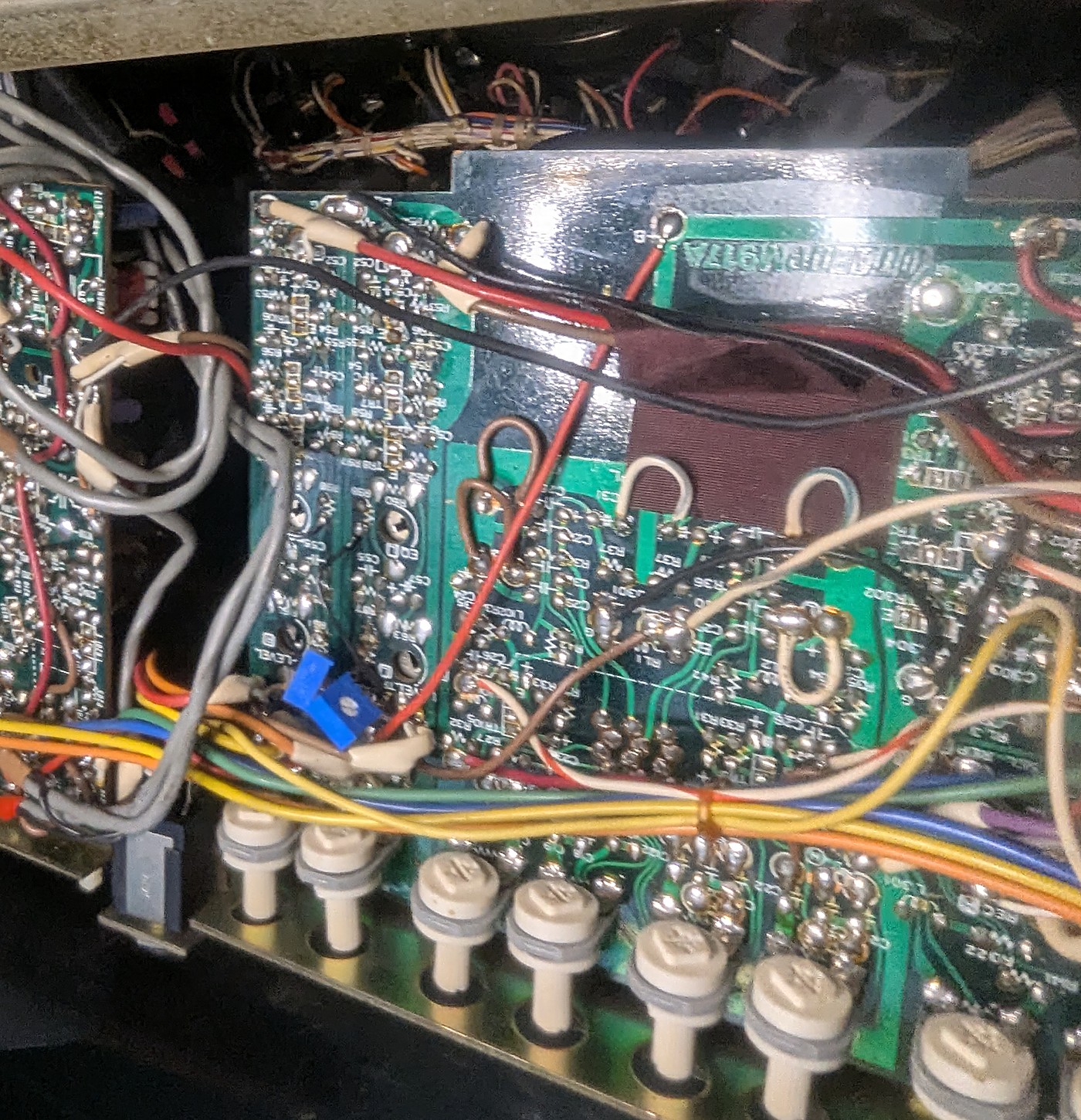 The rec/EQ board flipped solder-side up, still wired into the loom — the working method on a first-gen deck.