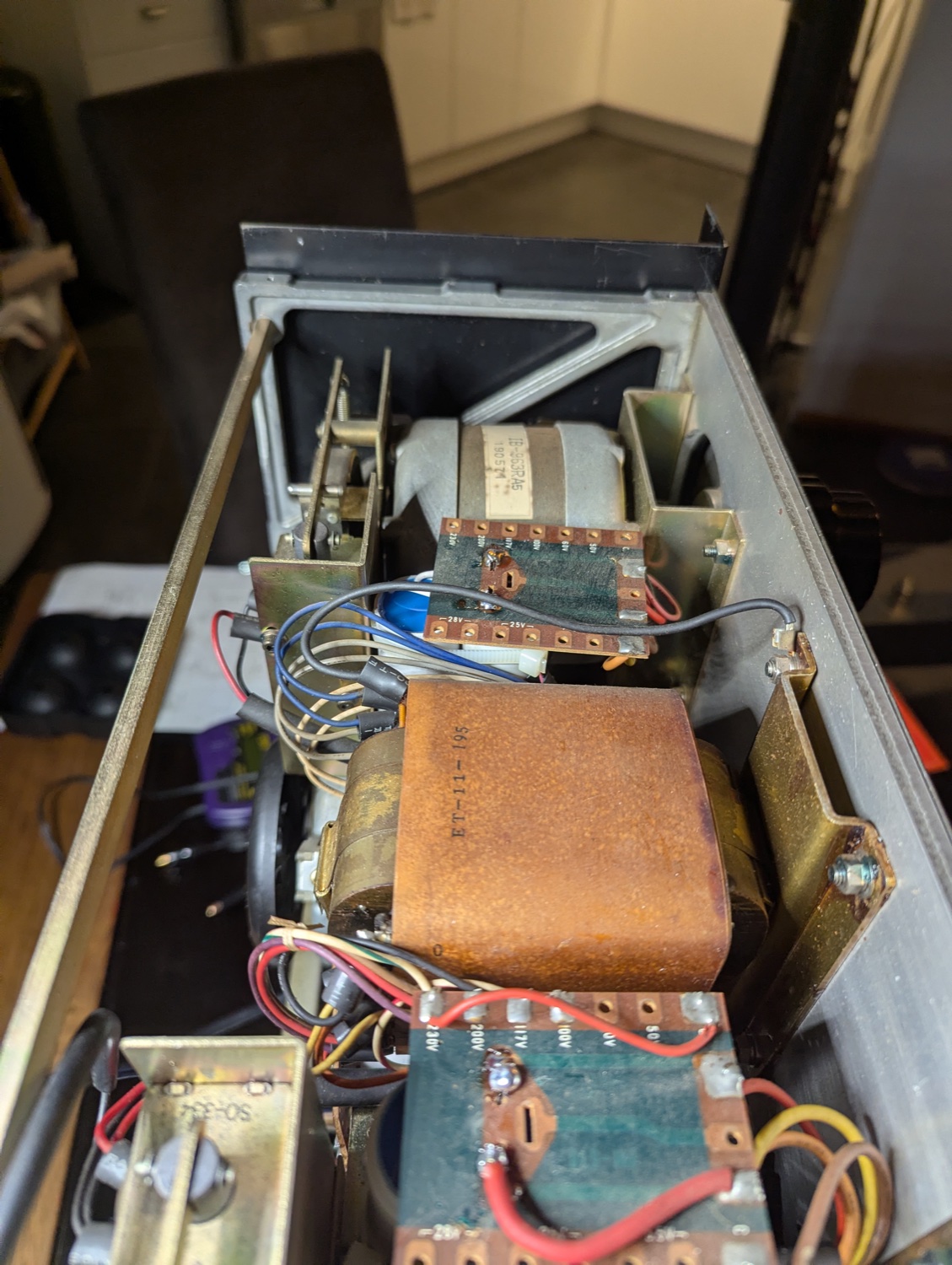The electronics bay re-capped — new motor-run cans in the original, gently bent-in brackets.